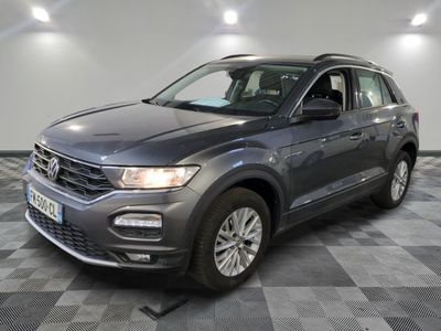 a grey volkswagen t - cross parked on a checkered floor