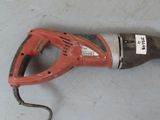 a corded drill on a table with a cord