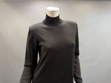 the mannequin is standing in front of a gray wall