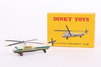 a toy helicopter and a box on a white surface