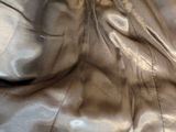 a yellow umbrella sitting on top of a black leather couch