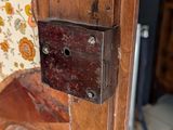a wooden door with a padlock on it in a room