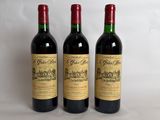 three bottles of wine sitting on top of a table next to each other