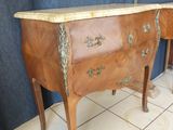 two wooden tables with drawers on them in a room