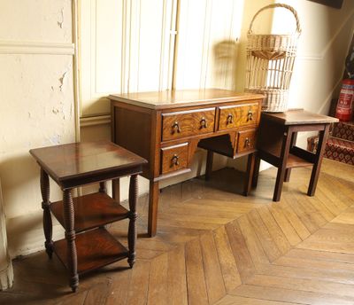 two tables and a dresser in the corner of a room