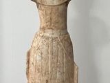 statue of a woman in a dress standing on a black base