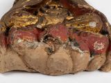 a piece of bread that is covered in gold and red paint