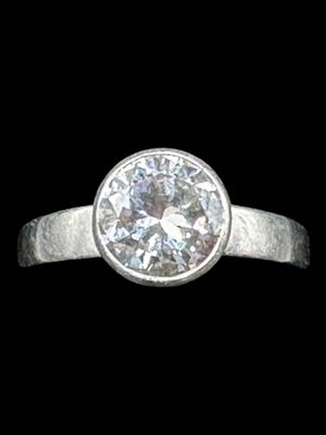 a close up of a diamond ring on a black background