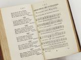 an open book with music notes on it on a table