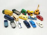 a lot of toy cars and trucks on a white surface