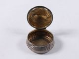an image of a small silver box with a bird on it