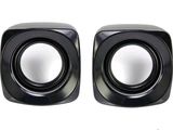 pair of black speakers on a white background with a reflection of the speaker