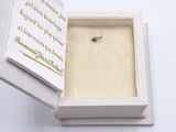a white box with a gold cross inside of it
