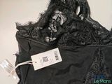 black lace bralette with a tag on the back of it