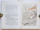 an open book with a drawing of a woman laying on a bed