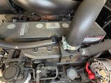a close up of a car engine with its hood open