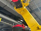 a robot that is working on a machine in a factory