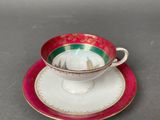tea cup and saucer with red rim and gold trim