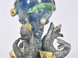 a blue vase with two fish on it and a fish on the bottom