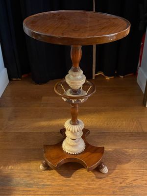 a wooden table with a glass top on a hard wood floor