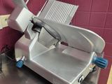 an image of a commercial meat slicer in a kitchen