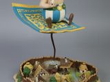 a figurine of a man sitting on top of a boat