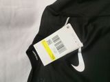 a close up of a black and white shirt with a tag on it