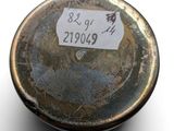 a small metal object with a sticker on it