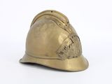 a gold fireman ' s helmet on a white background