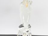 a glass sculpture of a giraffe standing on a table