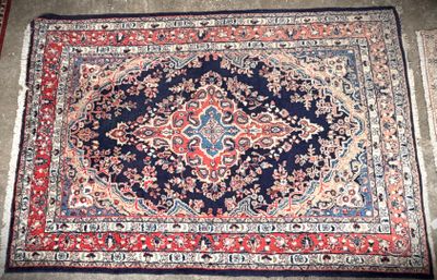 a close up of a rug on a floor with a red and blue rug