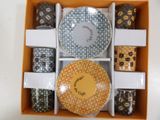a box that has a variety of cups and saucers in it
