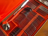 a red case with silverware in it on a table