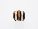 a close up of a tiger eye and diamond ring on a white background