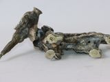 statue of a bird sitting on a branch with a bird on it ' s back