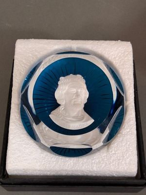 an image of a glass plaque with a picture of a man in a blue circle