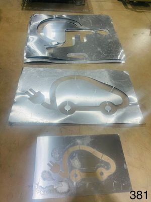 three pieces of metal on a table with a picture of a car on it