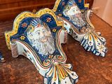three blue and white figurines sitting on a wooden table