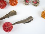 many different types of hair clips on a white surface