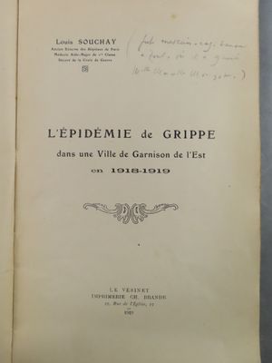 an old book with writing on it sitting on top of a table