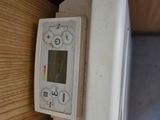 a digital thermometer on the wall of a room