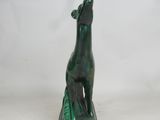 statue of a green dog on a green base on a white background