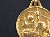 an image of a close up of a gold medal on a black surface