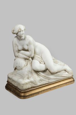an image of a statue of a woman laying on top of a table
