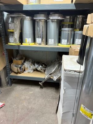 many cans of paint on a shelf in a store