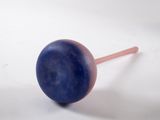 a blue and pink lollipop sitting on a white surface