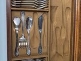 many spoons and silverware in a wooden box