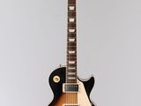 an electric guitar hanging from the ceiling in a room