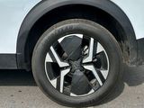 a close up of a tire on a white car