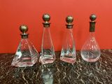 three glass decanters sitting on top of a marble table